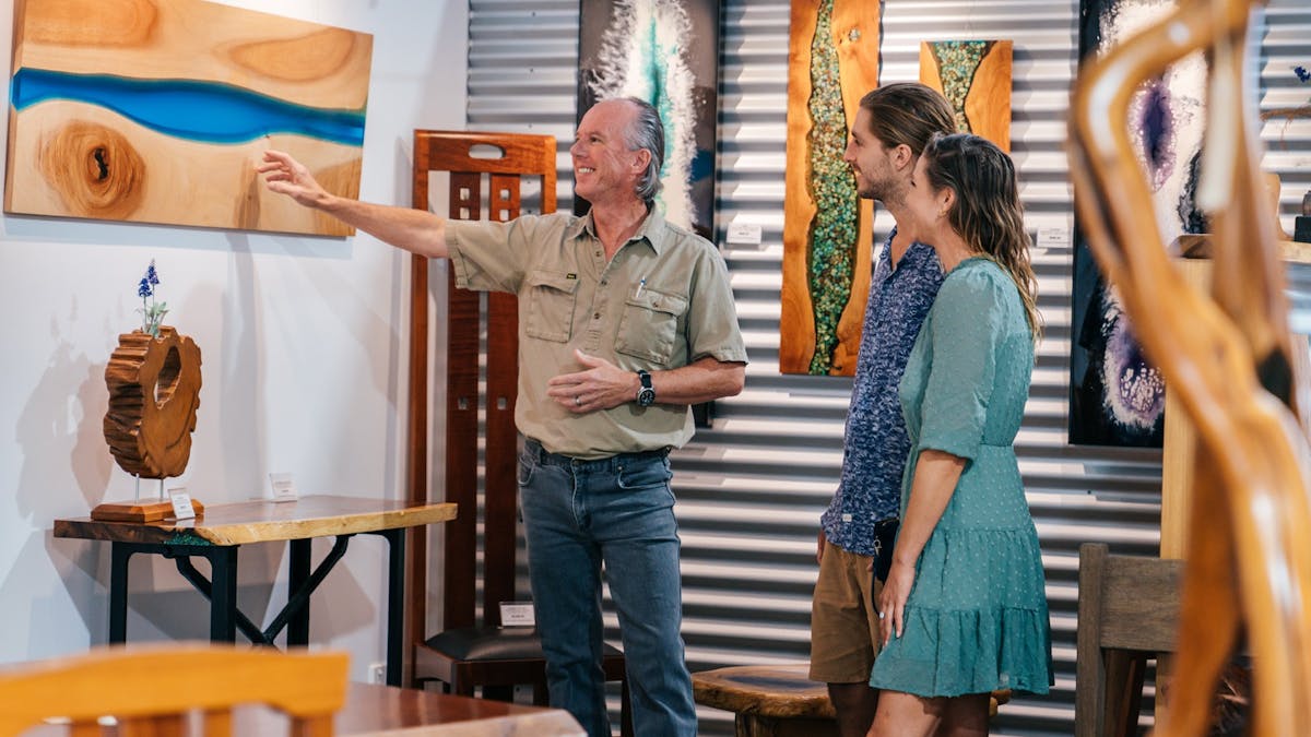 Visitors to David Suters Timbercraftsman Gallery Eumundi viewing timber art and meeting the maker