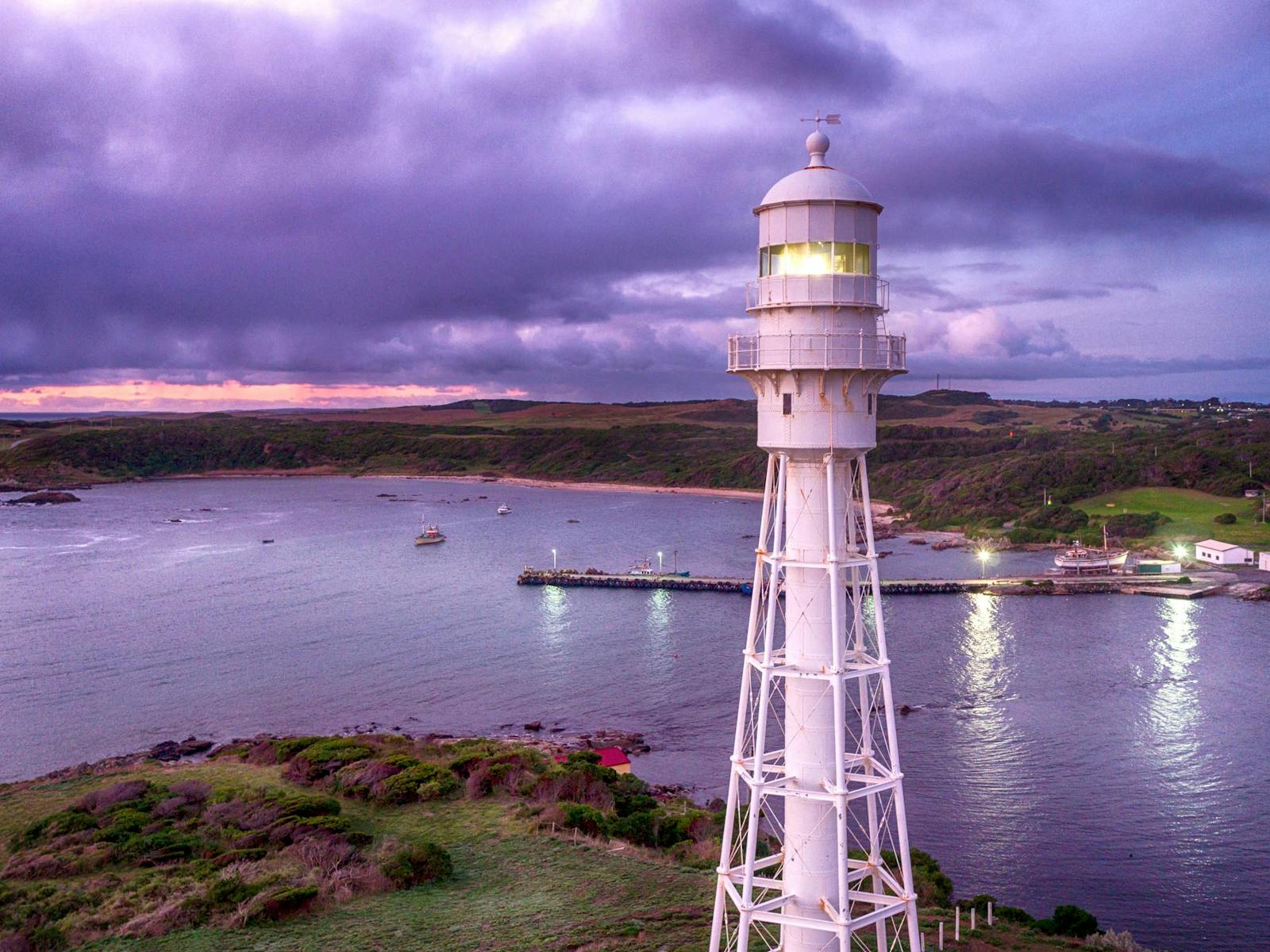 View of the Currie Lighthouse with Currie Harbour in the background.  The photo was taken at dusk