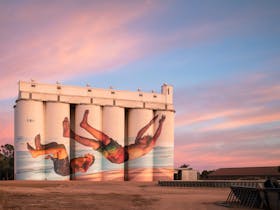Martin Ron's iconic silo mural at dusk featuring two boys jetty jumping