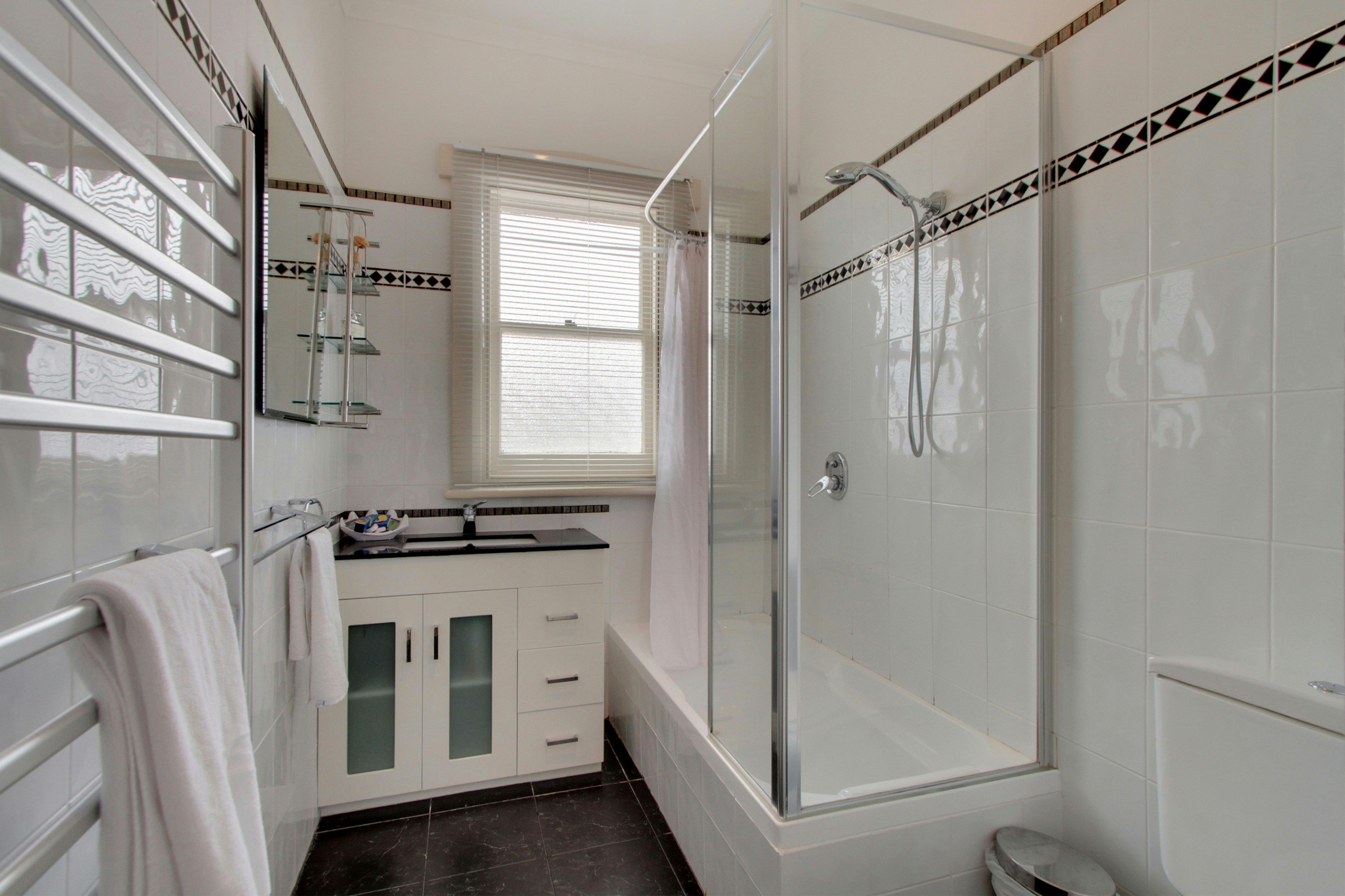 Bath, heated towel rail, hair dryer, toilet