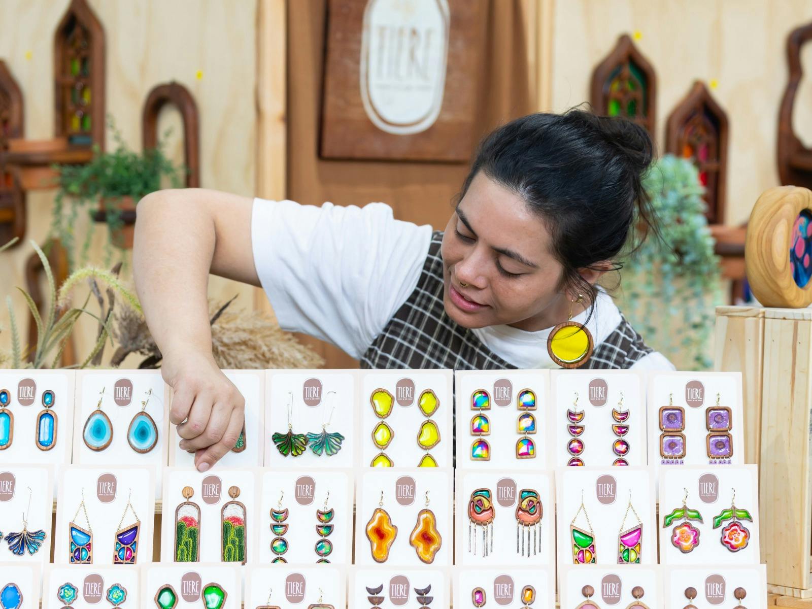 Tiere + Co looking at her display of earrings