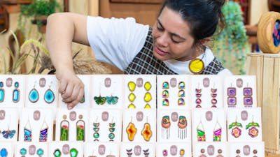 Tiere + Co looking at her display of earrings