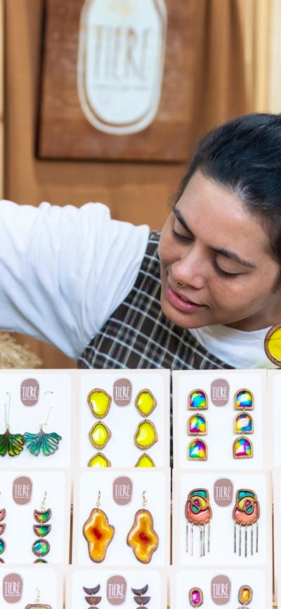 Tiere + Co looking at her display of earrings