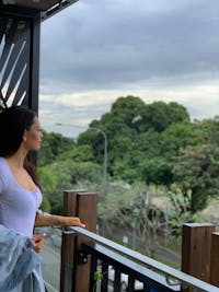 girl on balcony looking at the view trees