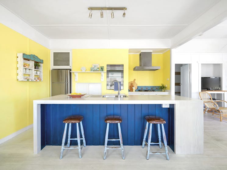 A gourmet's kitchen with under-bench stools