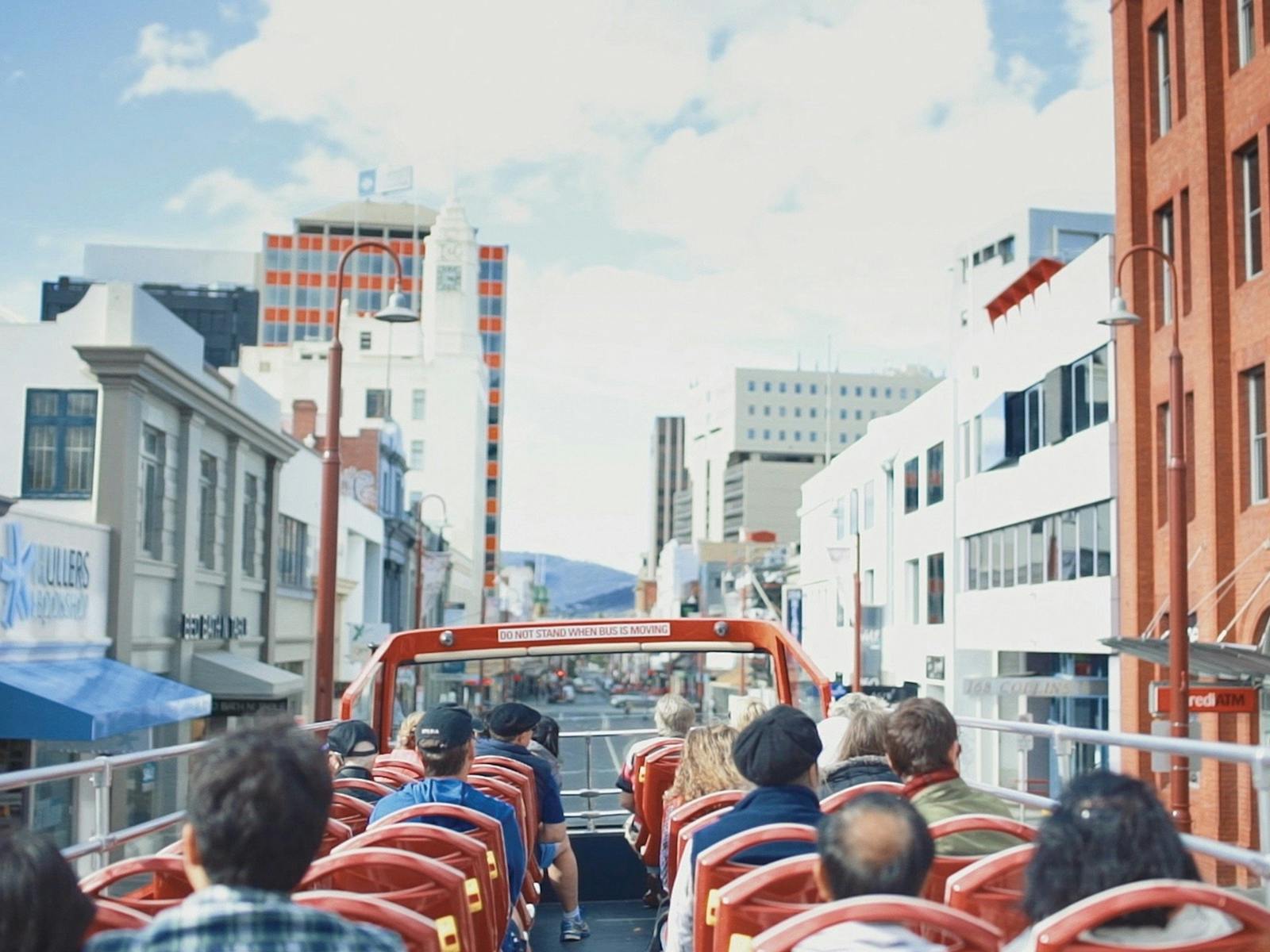A double decker bus travels through the city streets of Hobart.