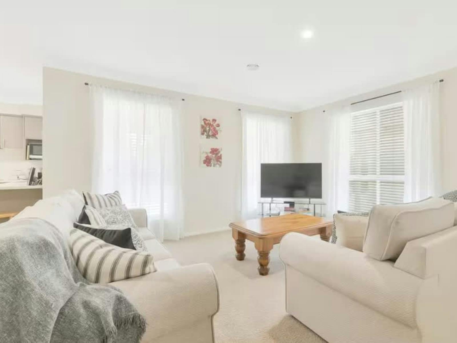 Lounge room with 2 sofas, a tv and coffee table
