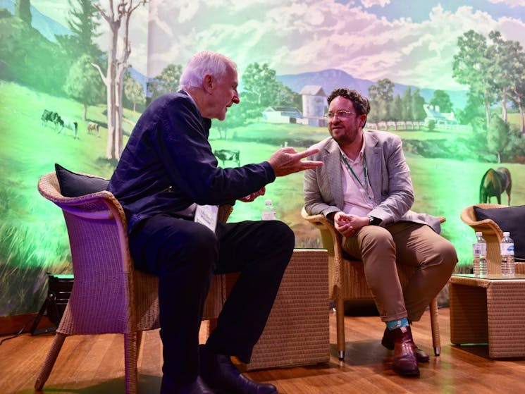 Two men on stage in conversation