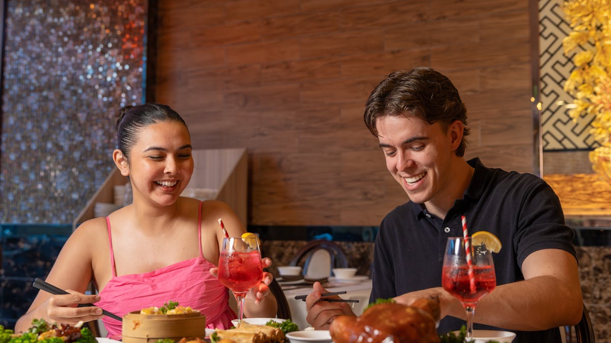 A man and woman eating and laughing at Circle on Cavill