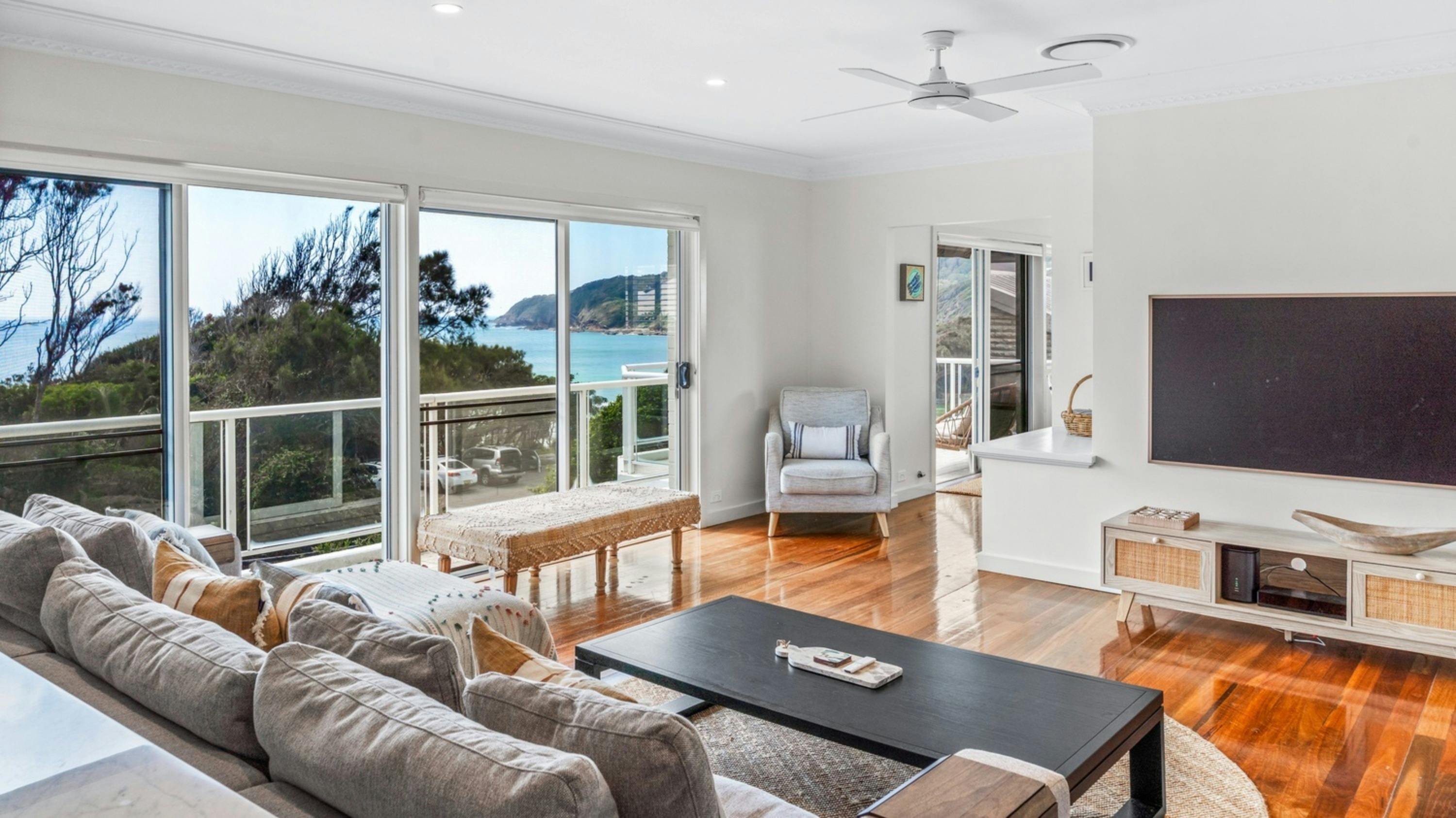 Living room with ocean and mountain view