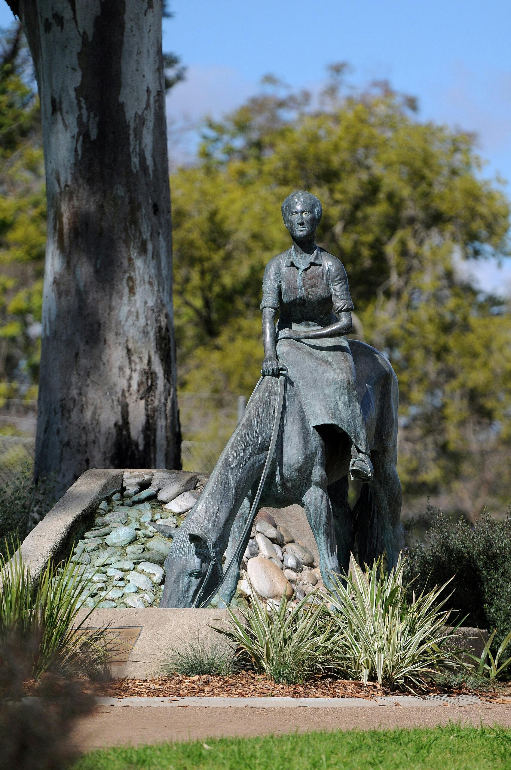 bronze statue of woman on a horse