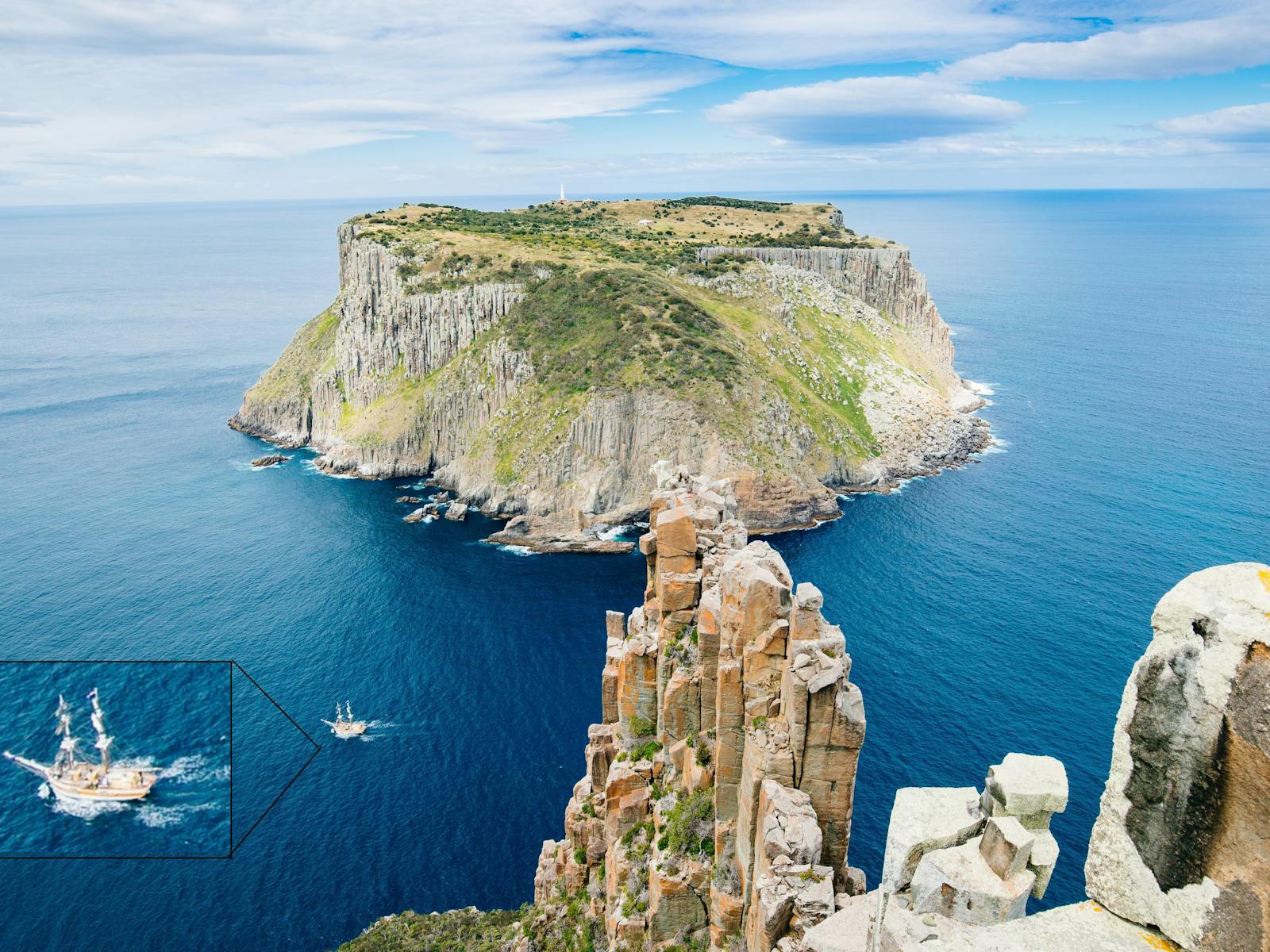 Tall Ship Lady Nelson dwarfed by the epic Southern Tasmanian Coastline