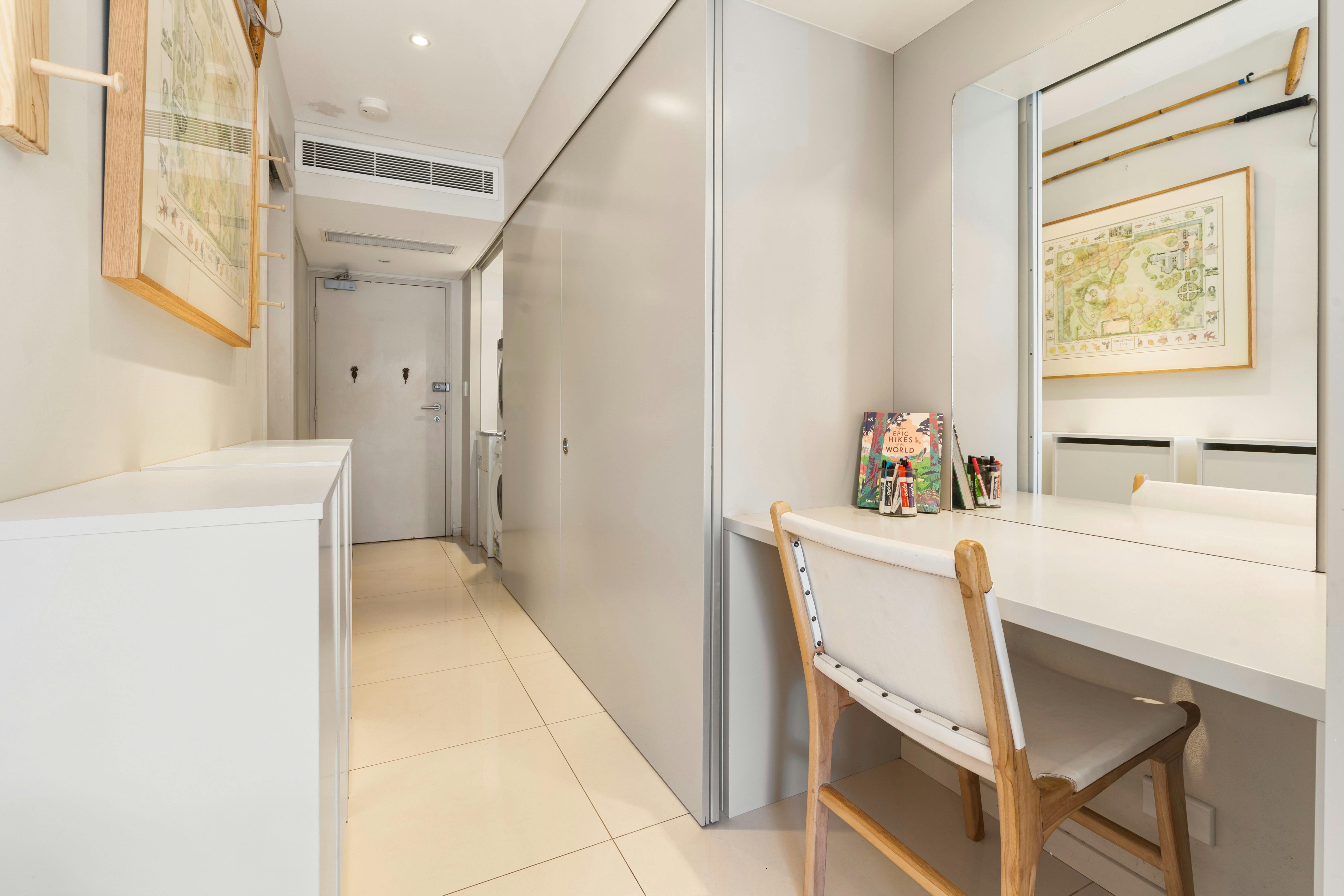 Modern kitchen and living space with a turquoise splashback and a cozy private courtyard.