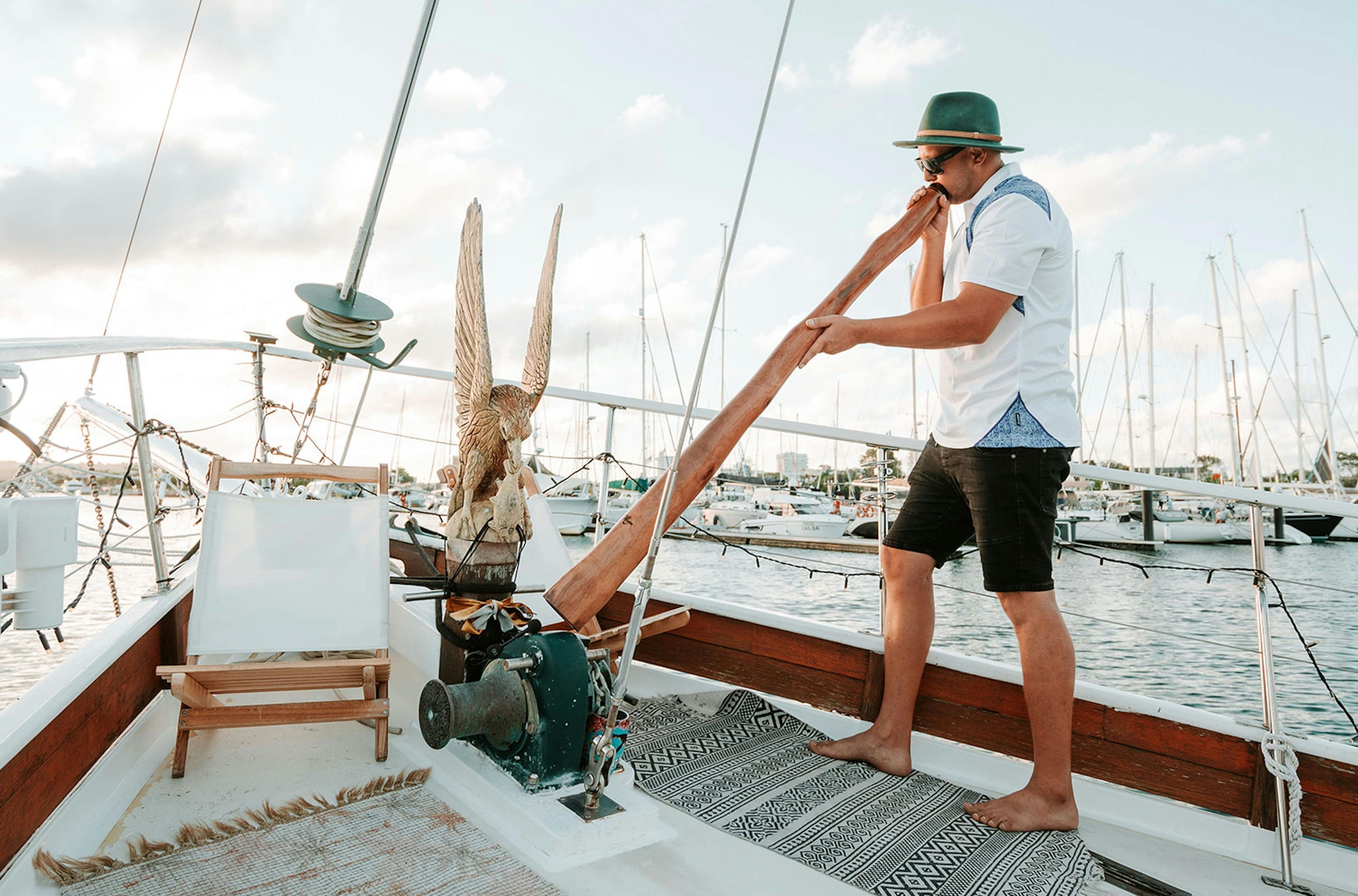 Captain playing Didgeridoo onboard Saltwater Eco Tours
