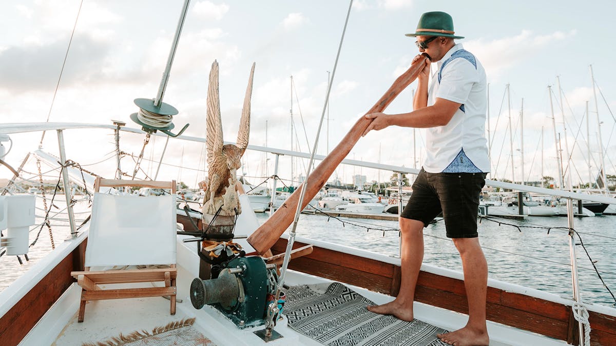 Captain playing Didgeridoo onboard Saltwater Eco Tours Captain playing Didgeridoo onboard Saltwater Eco Tours