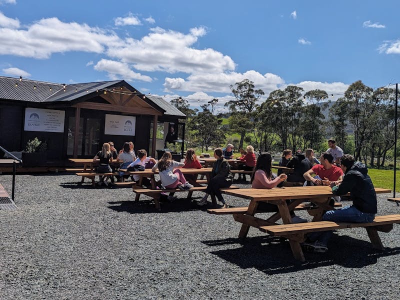 Groups sat on picnic benches outside a cafe