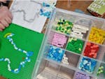 Lego Dots on a Lego baseplate, pixelated dog