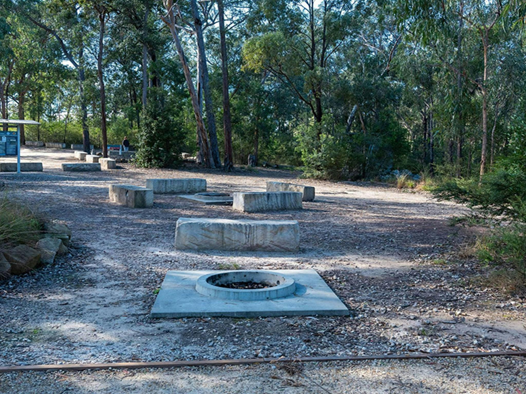 Concrete firepits with seating at Finchley campground in Yengo National Park. Credit: Allan Chawner