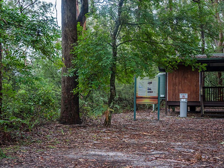 View of toilet block set in a sandy clearing surrounded by trees. Photo: John Spencer &copy; DPIE