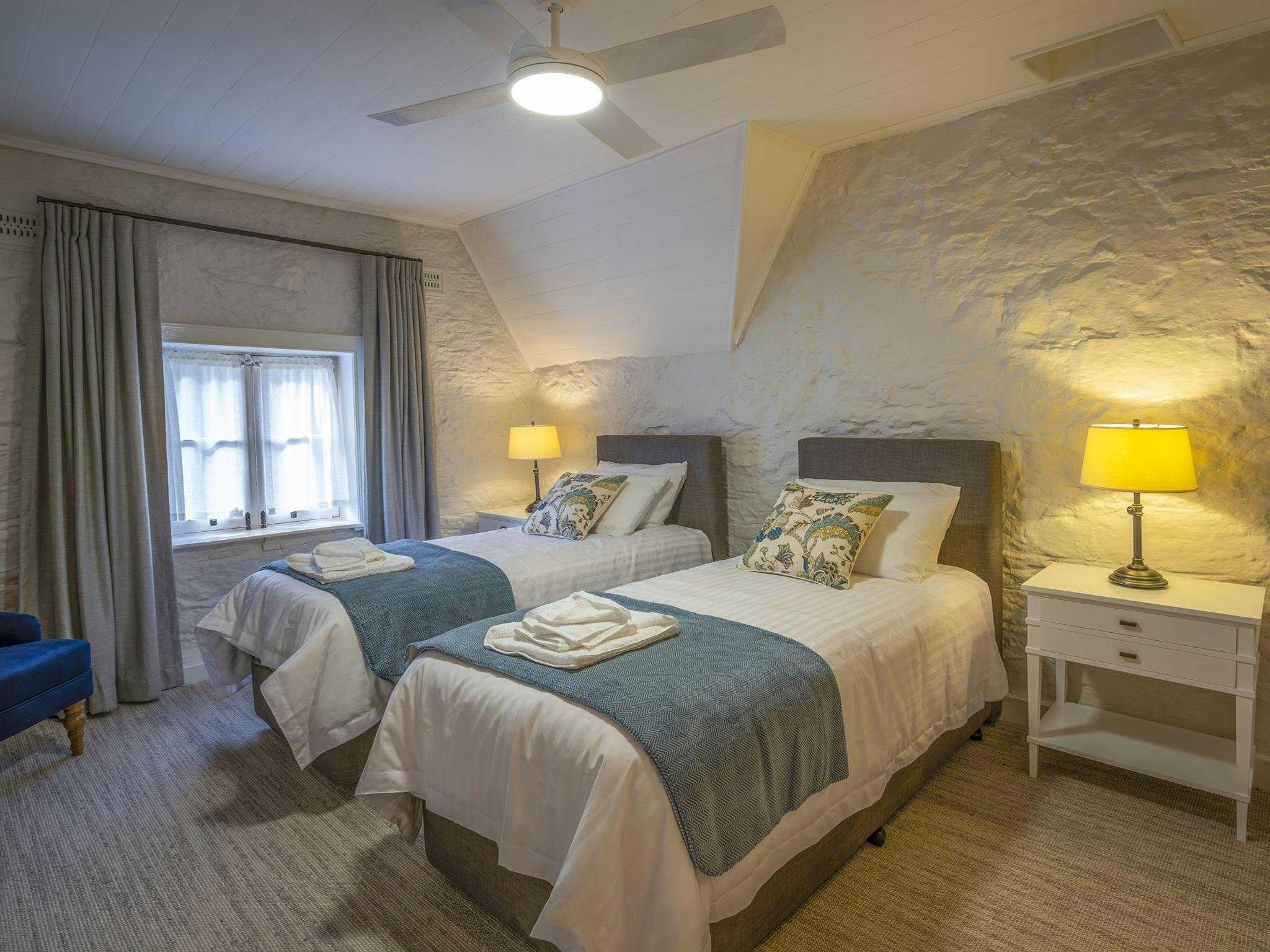 A bedroom with 2 single beds at Gardeners Cottage, Sydney Harbour National Park. Photo:  John