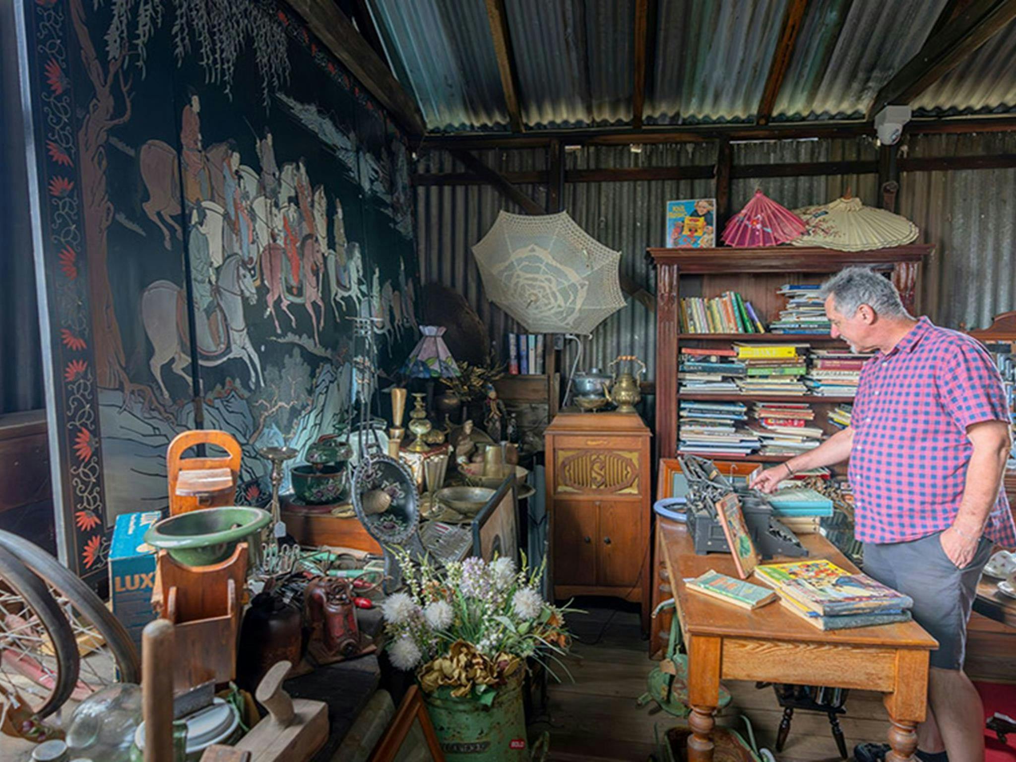 A visitor browsing antiques for sale at Gold Rush Antiques in Hartley Historic Site. Credit: John