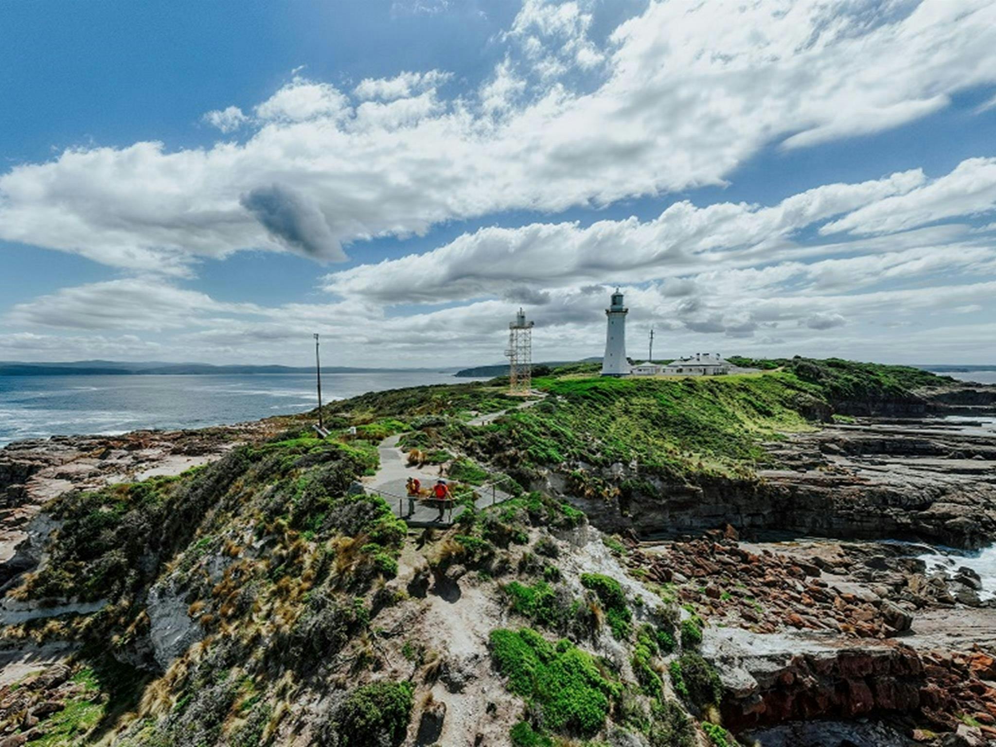 Visitors enjoy rugged coastal views from Green Cape lookout, Beowa National Park. Credit: Daniel