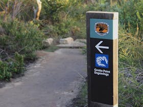 Signposts point the way to Grotto Point Aboriginal engravings off Manly scenic walkway. Photo: