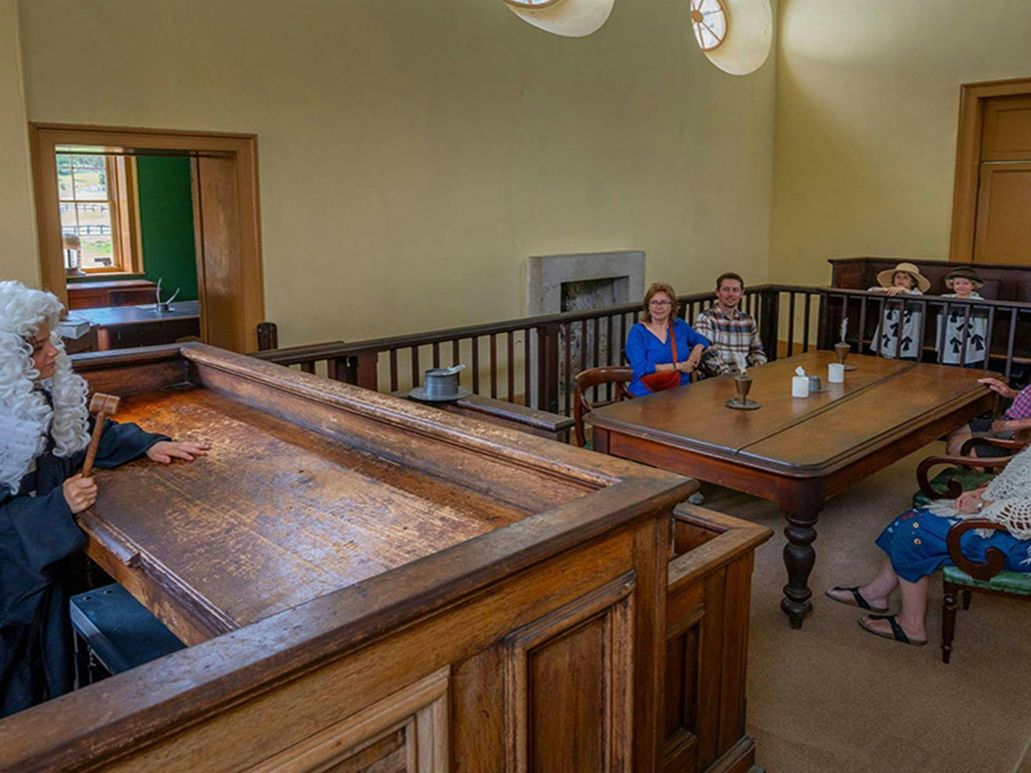 A child dressed as a judge on the judges bench pretending to address visitors inside Hartley