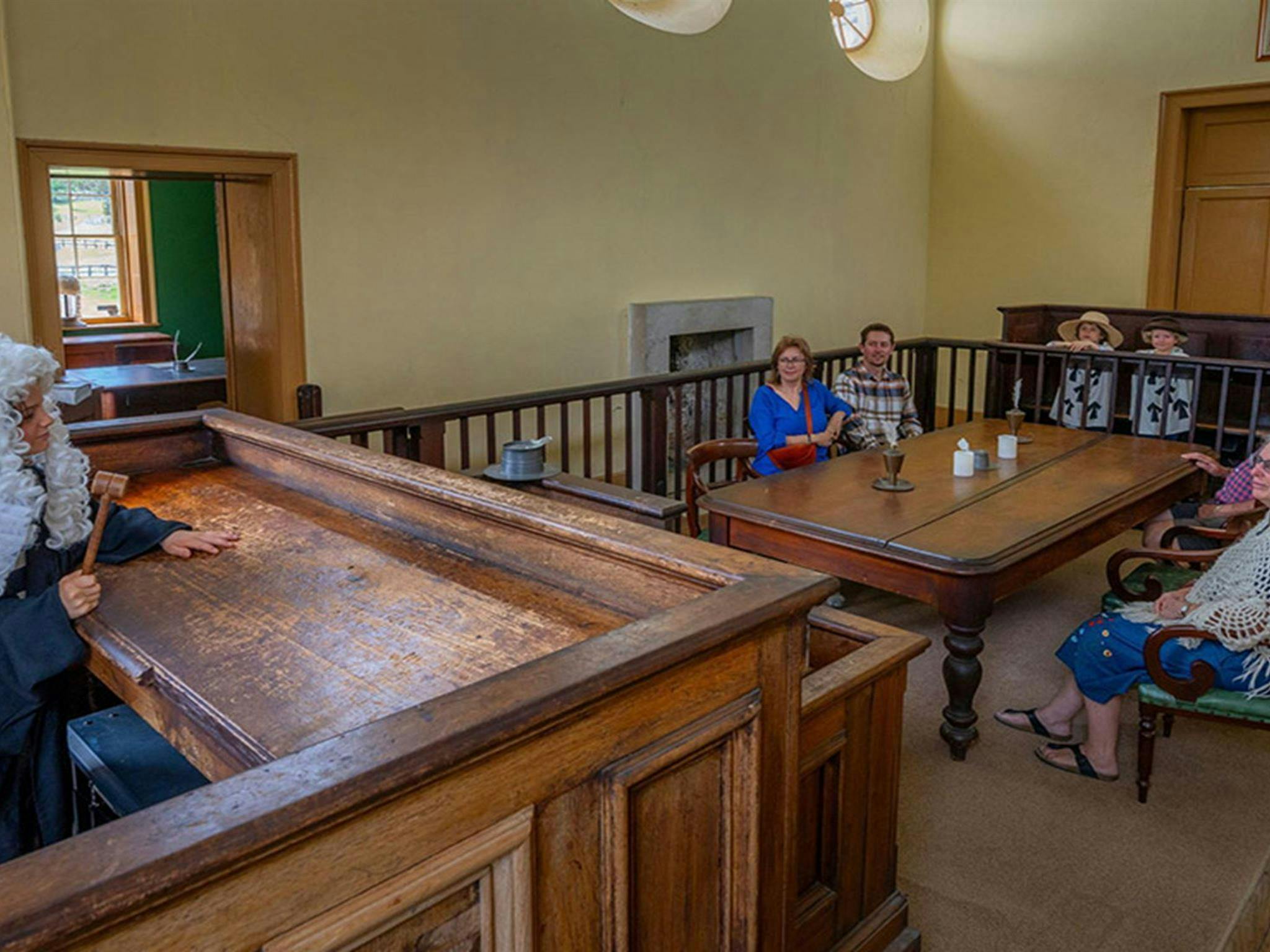 A child dressed as a judge on the judges bench pretending to address visitors inside Hartley