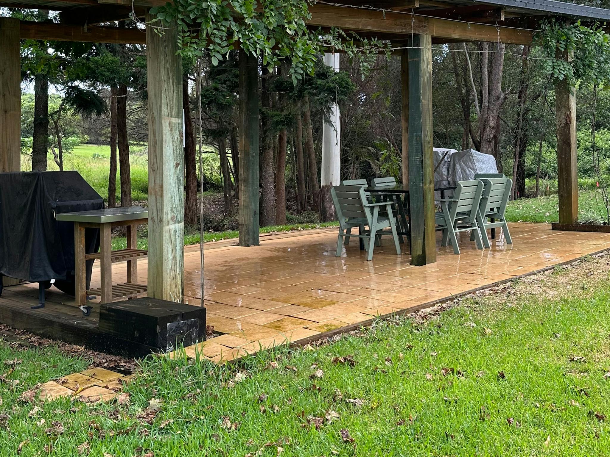 Large covered bbq area with a table and chairs. Also a fire pit for those cold nights.