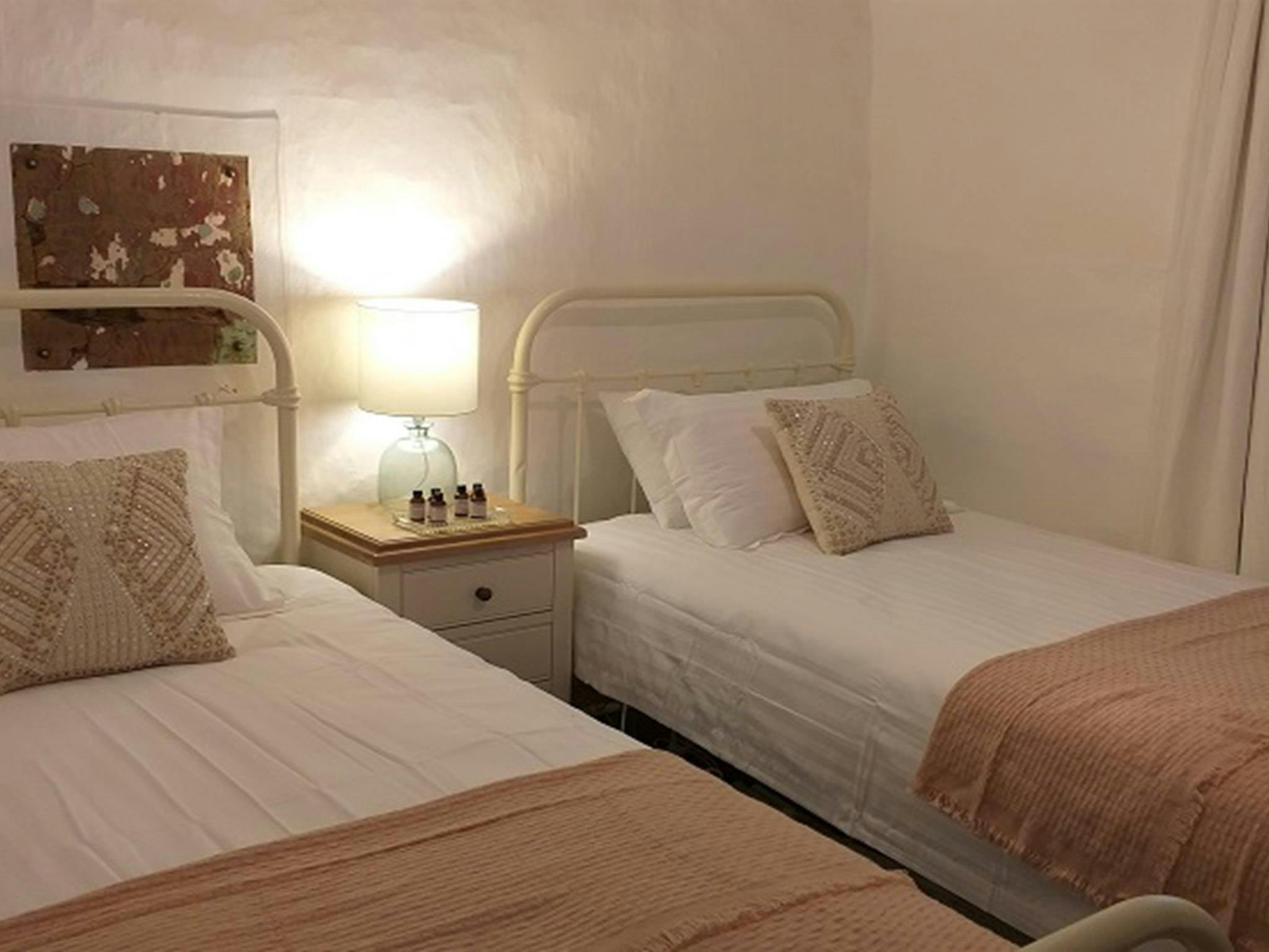 Bedroom with 2 single beds at Hill End Pines Cottage, Hill End Historic Site. Photo: Brett