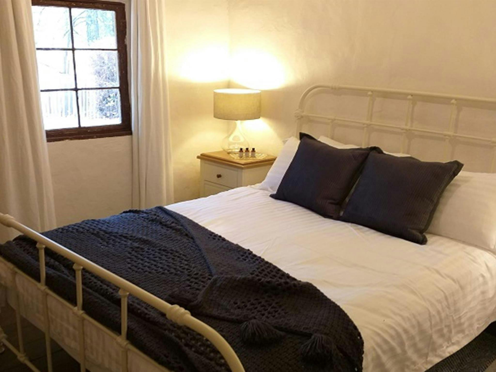 Bedroom with queen bed in Hill End Pines Cottage, Hill End Historic Site. Photo: Brett Kearins/DPIE