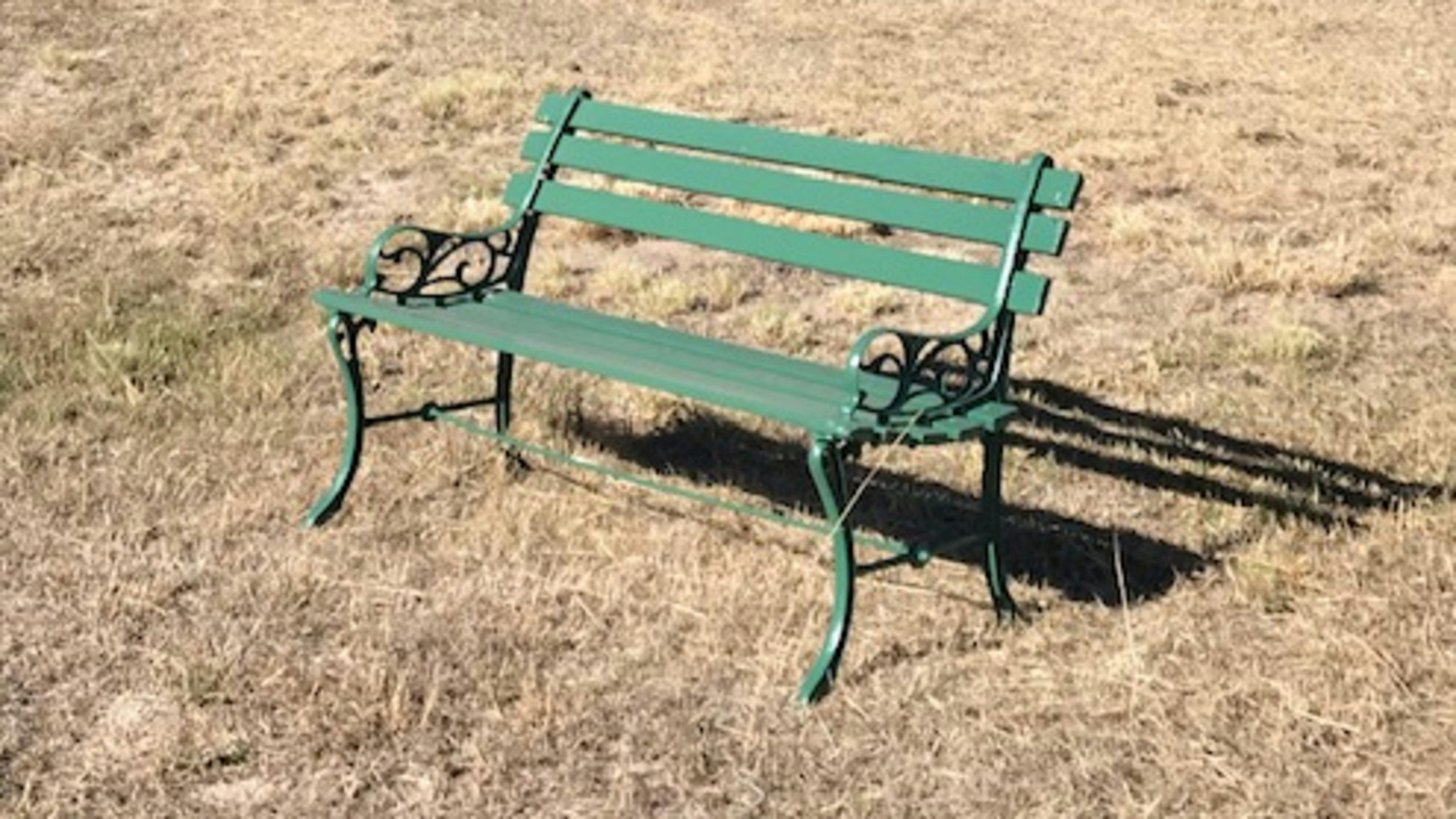 Camping Site framed by a small woodland with giant granite boulders and trees.