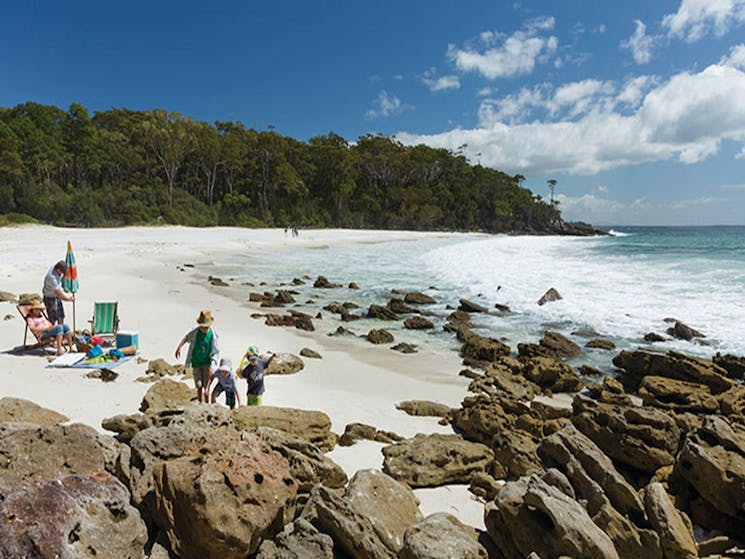 Children play beside their parents at Chinamans Beach, Jervis Bay National Park. Photo: David