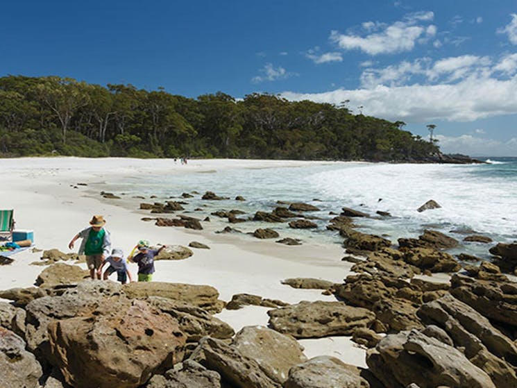 Children play beside their parents at Chinamans Beach, Jervis Bay National Park. Photo: David