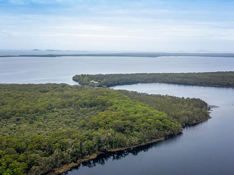 Aerial view of bush and water surrounding Joes Cove campground in Myall Lakes National Park. Photo: