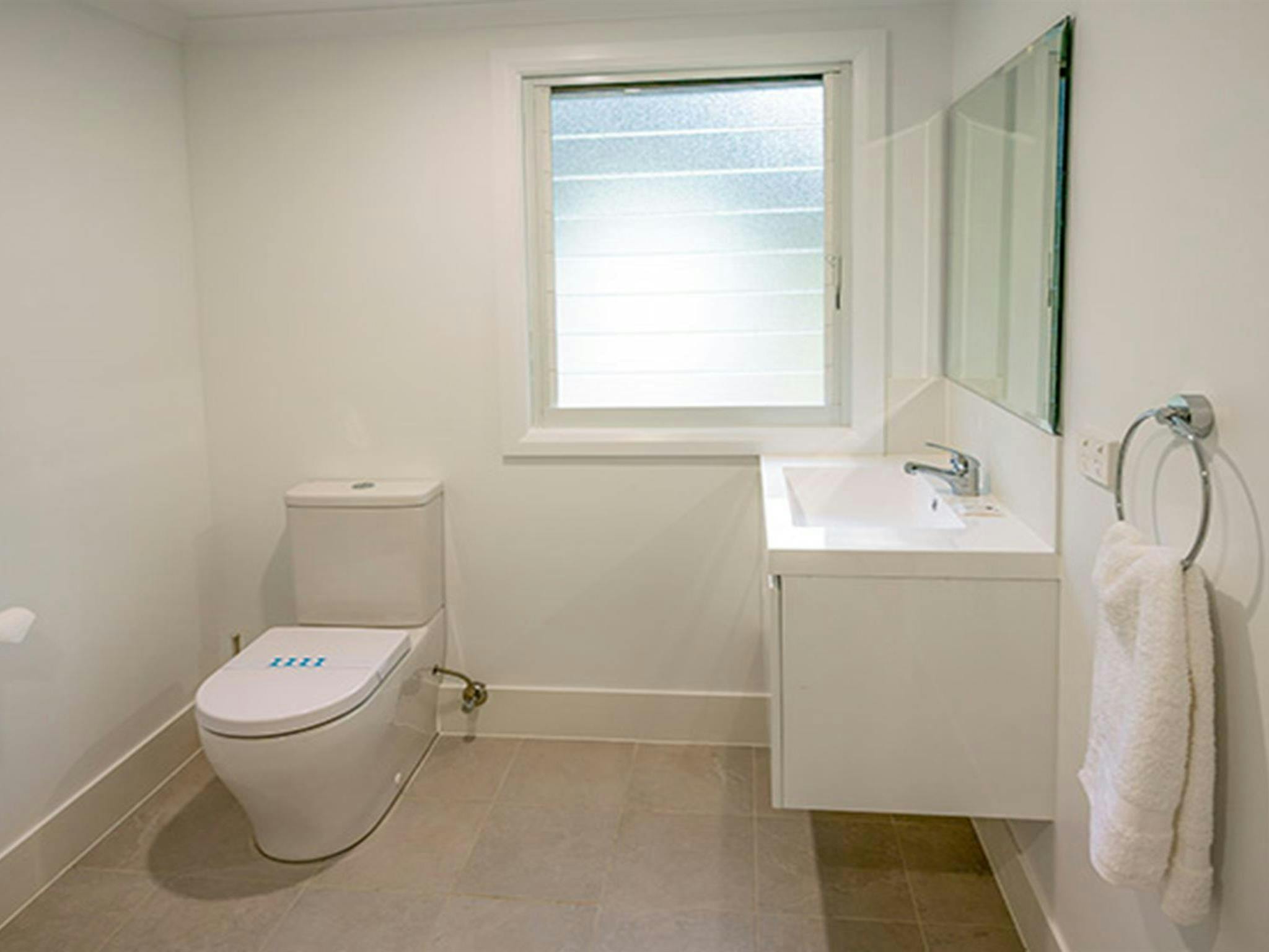Judges House bathroom with modern basin and toilet, Murramarang National Park. Photo: John Spencer