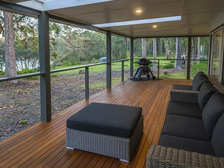 The covered verandah with lounge setting, barbecue and water views, Judges House, Murramarang