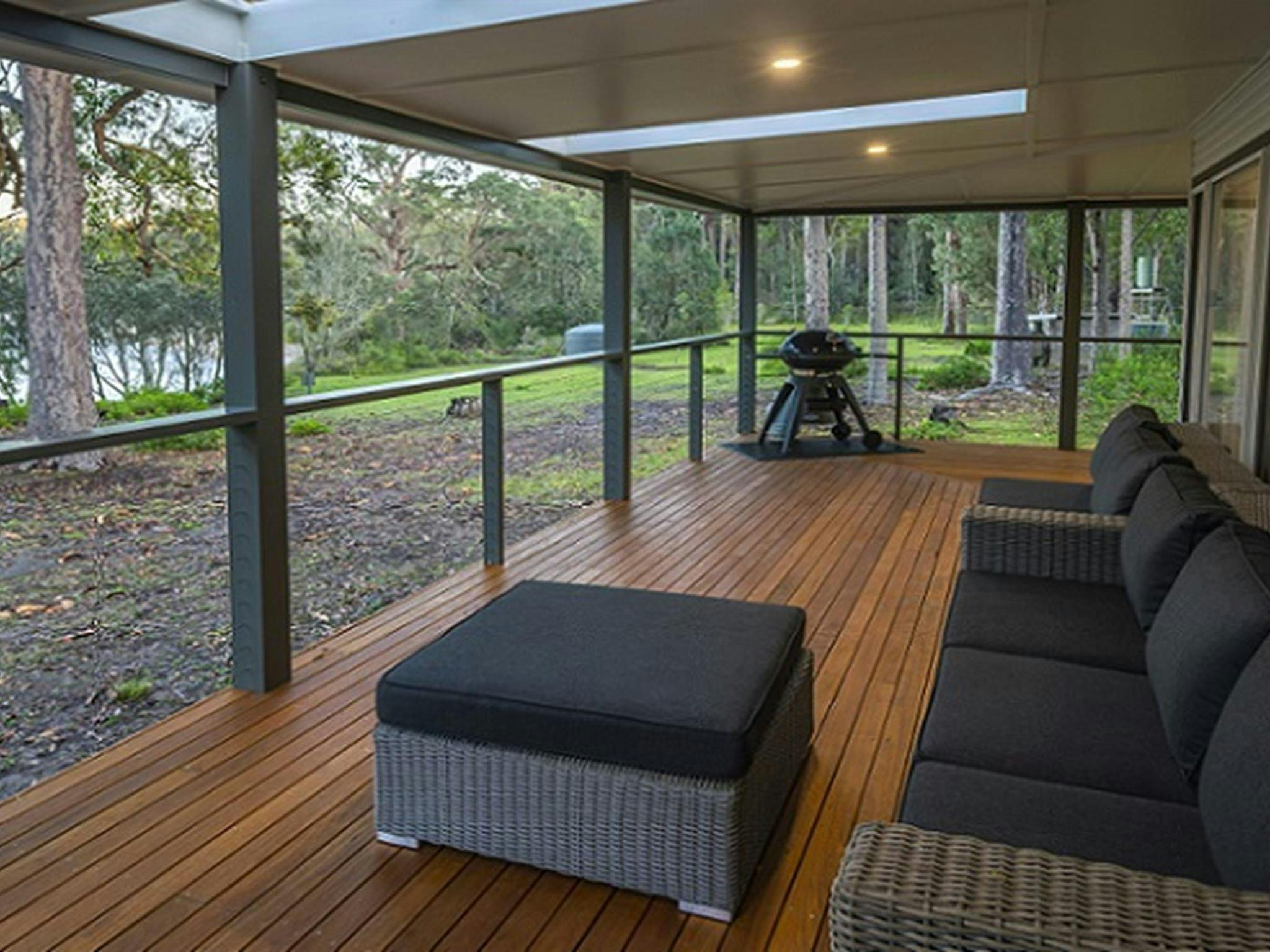 The covered verandah with lounge setting, barbecue and water views, Judges House, Murramarang
