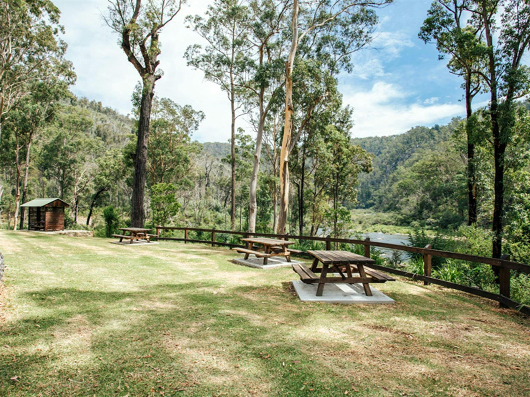Picnic tables by Nymboida River at The Junction campground, Nymboi-Binderay National Park. Photo: