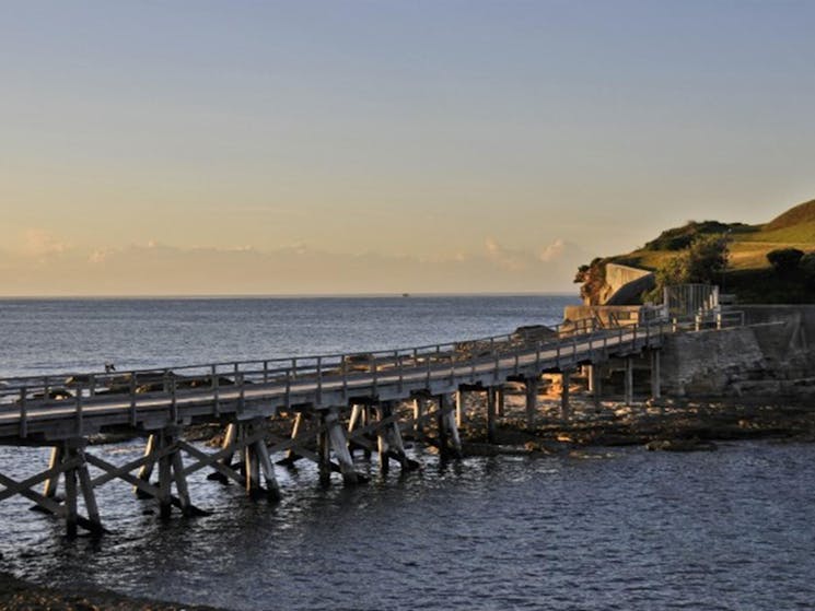 The wooden footbridge to Bare Island Fort at sunset in Kamay Botany Bay National Park. Photo: Kevin