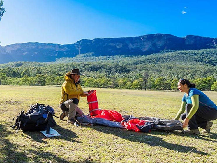 A couple set up a tent at Kedumba River Crossing campground, Blue Mountains National Park. Photo: