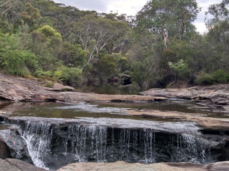 A small waterfall at Kingfisher Pool in Heathcote National Park. Photo: Jodie McGill &copy; DPIE