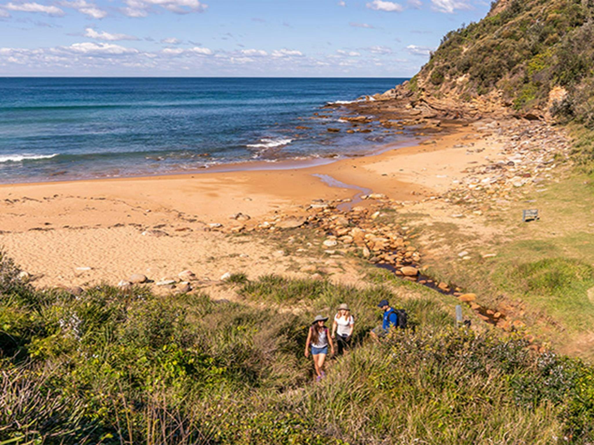 3 people walking up from the Little beach, Bouddi National Park. Photo: John Spencer/DPIE.