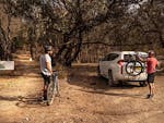 Two men take bikes off the back of a car at the start of a multi-use track in Livingstone National