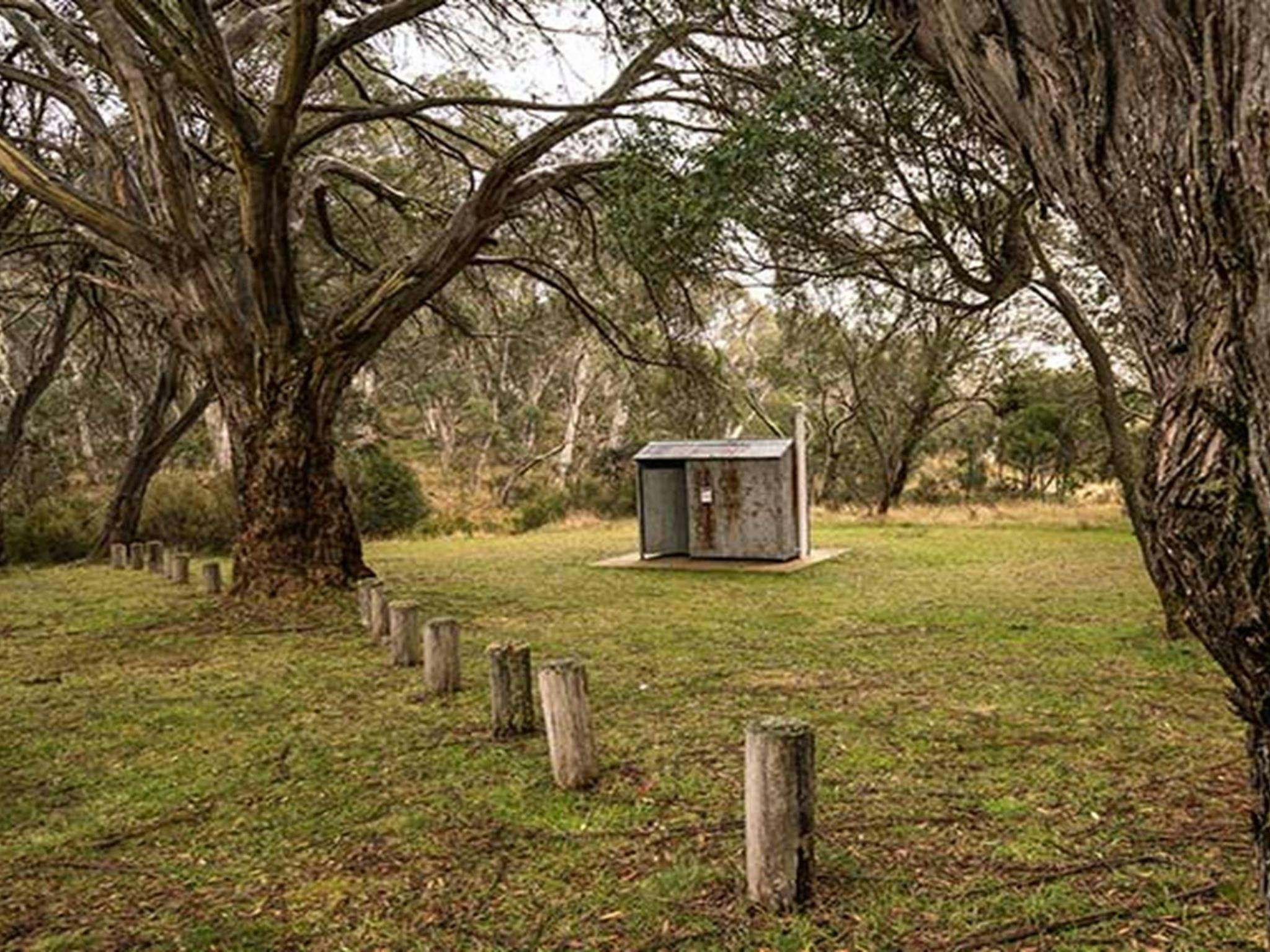 Non-flush toilet tin building among trees, Long Plain Hut campground, Kosciuszko National Park.