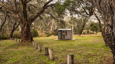 Non-flush toilet tin building among trees, Long Plain Hut campground, Kosciuszko National Park.
