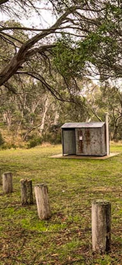 Non-flush toilet tin building among trees, Long Plain Hut campground, Kosciuszko National Park.