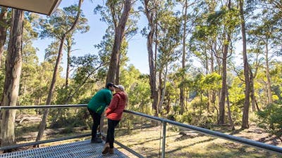 A couple on the verandah at Lyrebird Cottage, Kosciuszko National Park. Photo: Boen Ferguson/OEH.