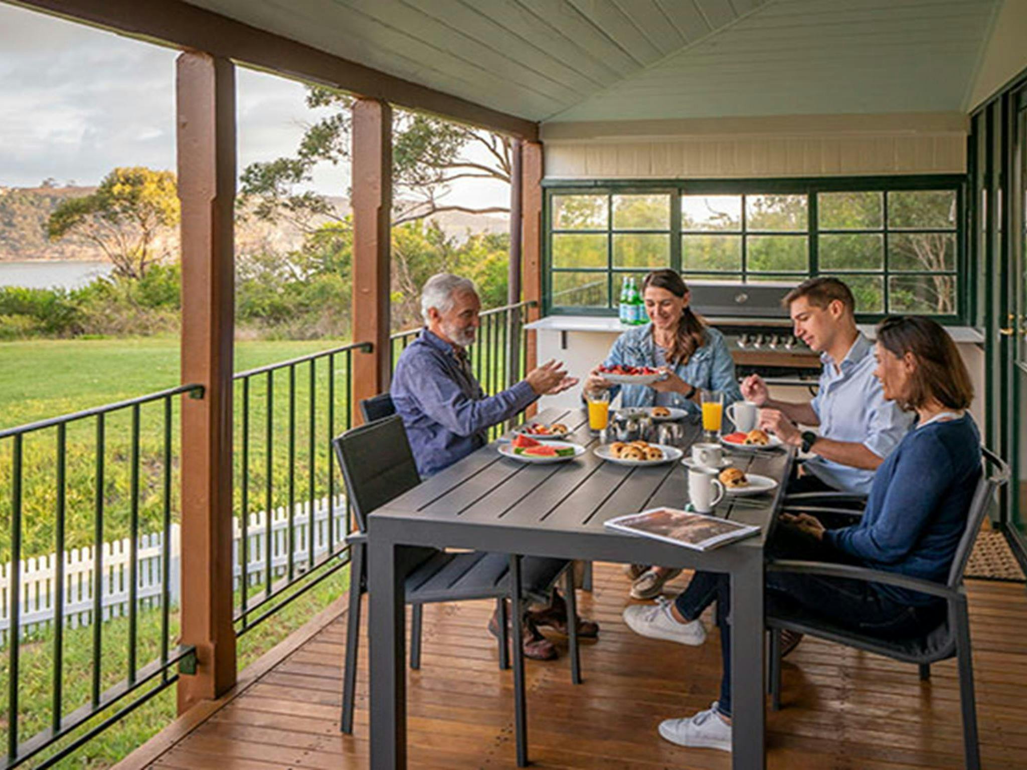 A group of friends having breakfast on the verandah at Middle Head Officers Quarters, Sydney Harbour
